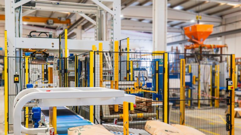 Palettiseur industriel automatisé en fonctionnement sur une ligne de production